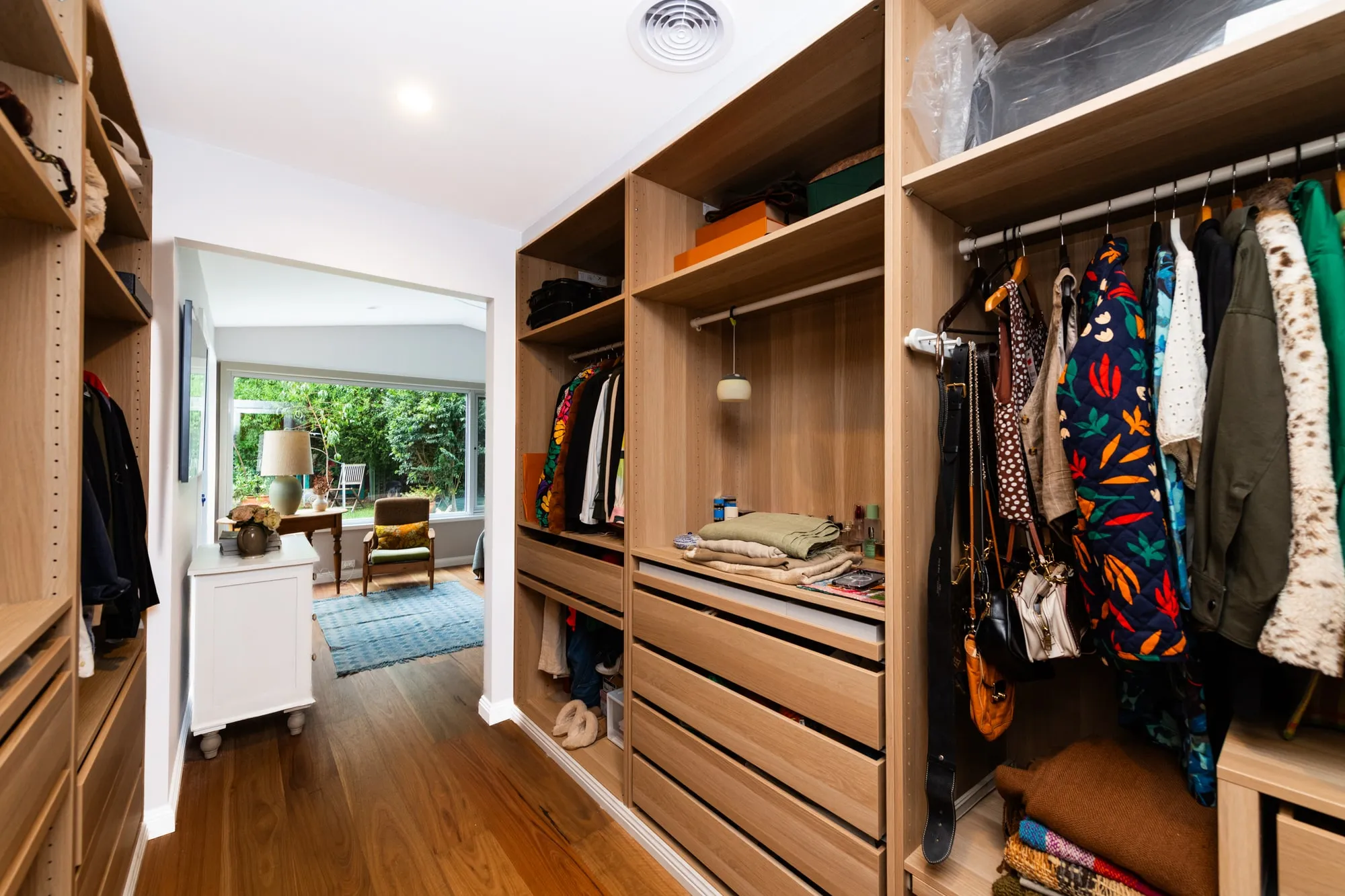 Clothes hanging in a walk in robe