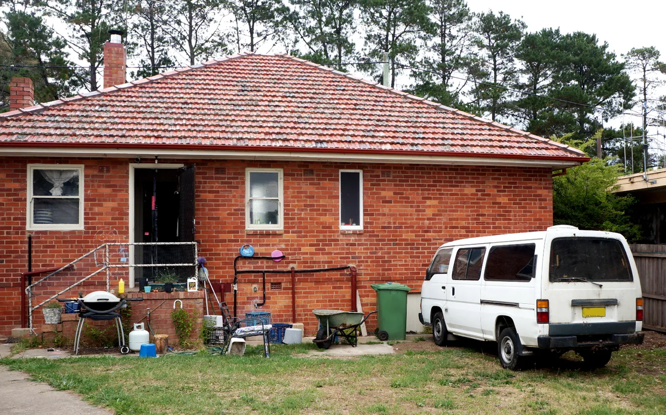Old house featuring Canberra red bricks and terracotta tiled roof.