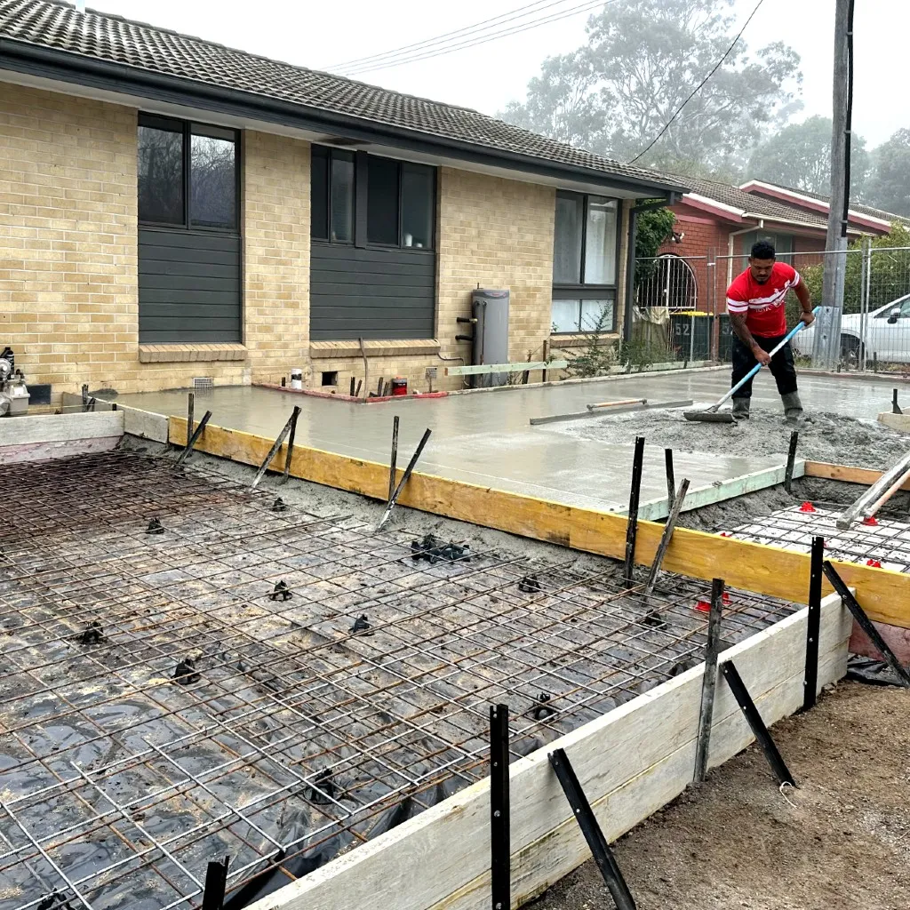 Worker smoothing the concrete during a pour