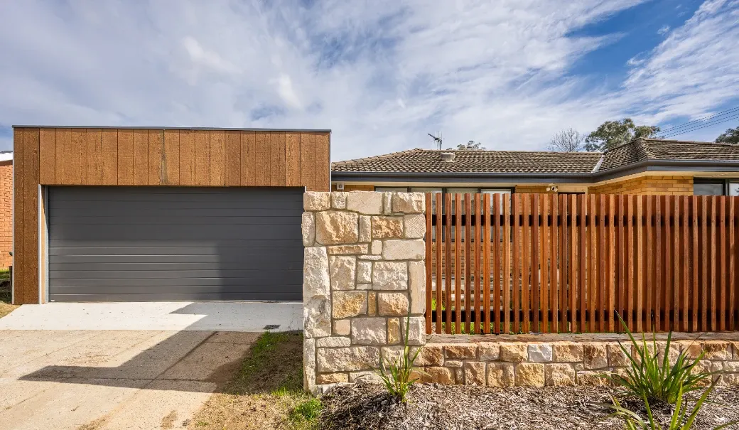 Newly completed timber carport and roller door. Newly completed sandstone courtyard wall.