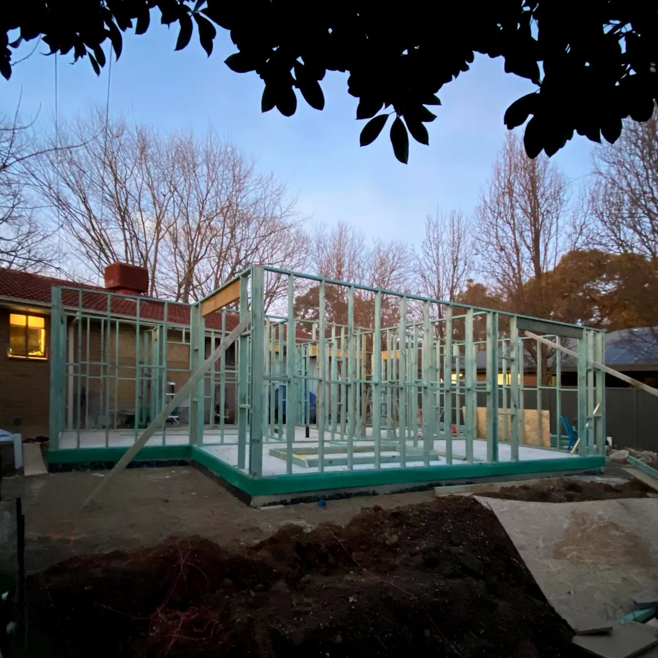 Construction site showing timber framing at sunset