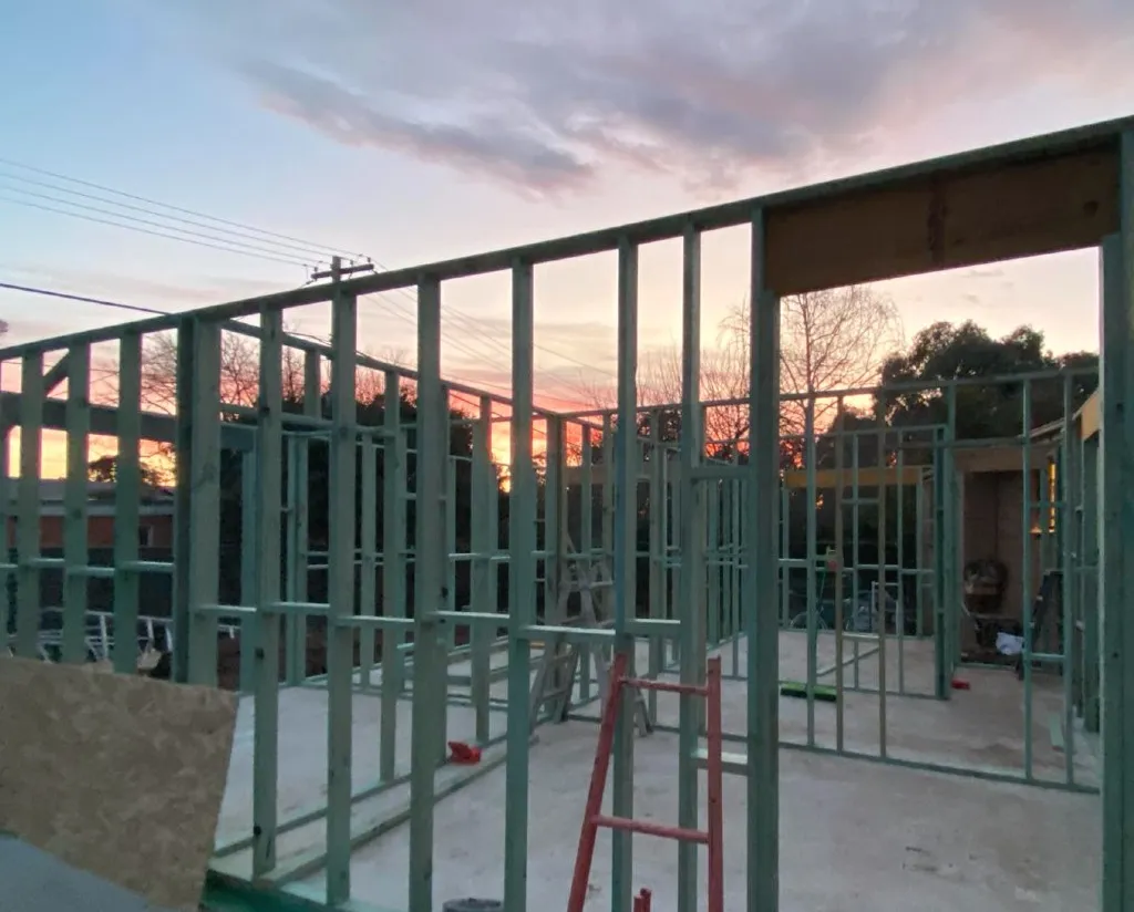 Construction site showing timber framing at sunset