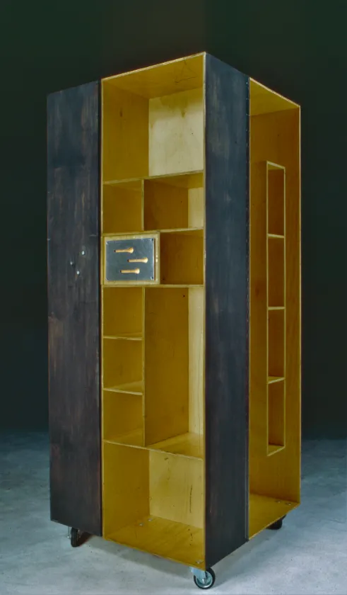 Tall cabinet with a dark exterior and yellow shelving inside, standing open