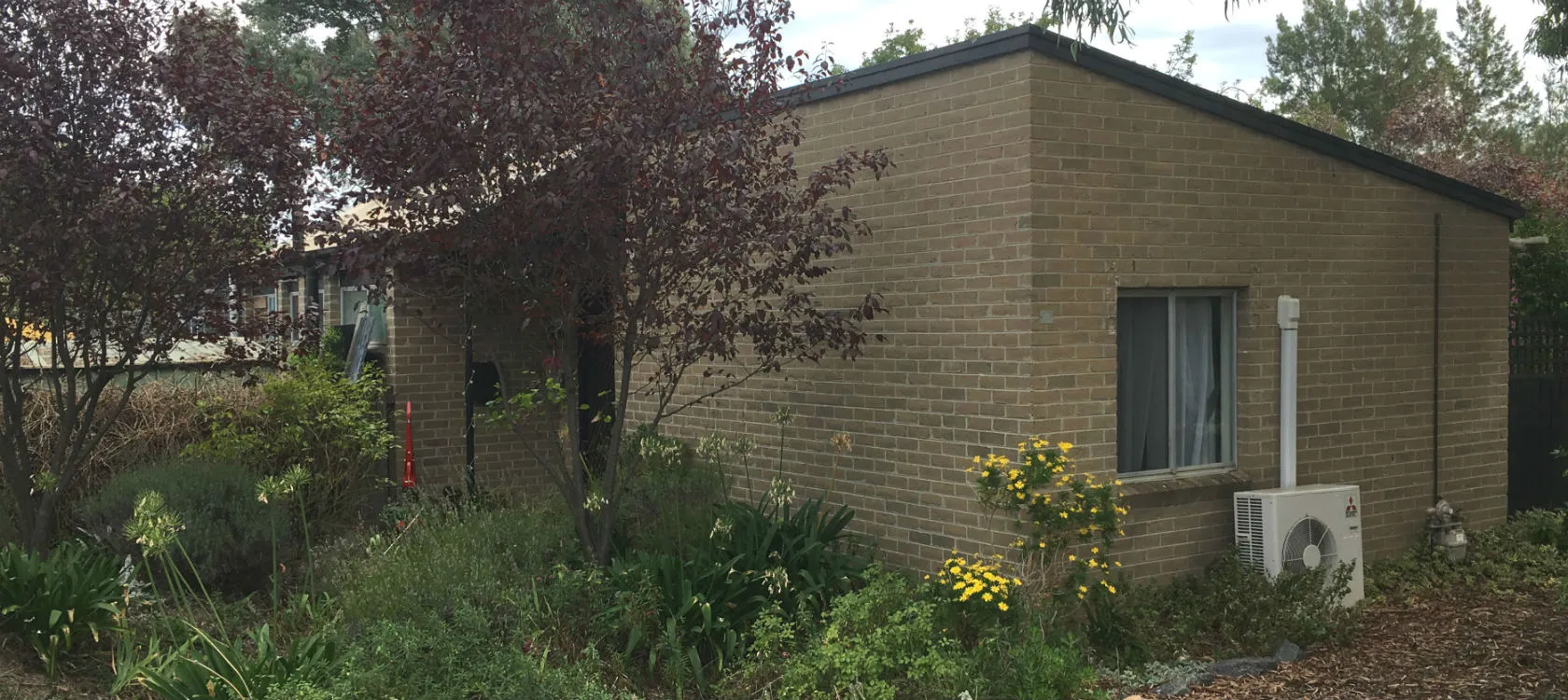 1970s gray brick house before extension is build